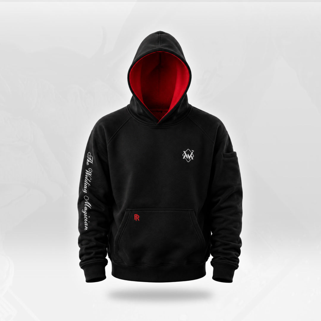 The Welding Magician black FR hoodie with red-lined hood, chest logo, sleeve lettering and front kangaroo pocket.