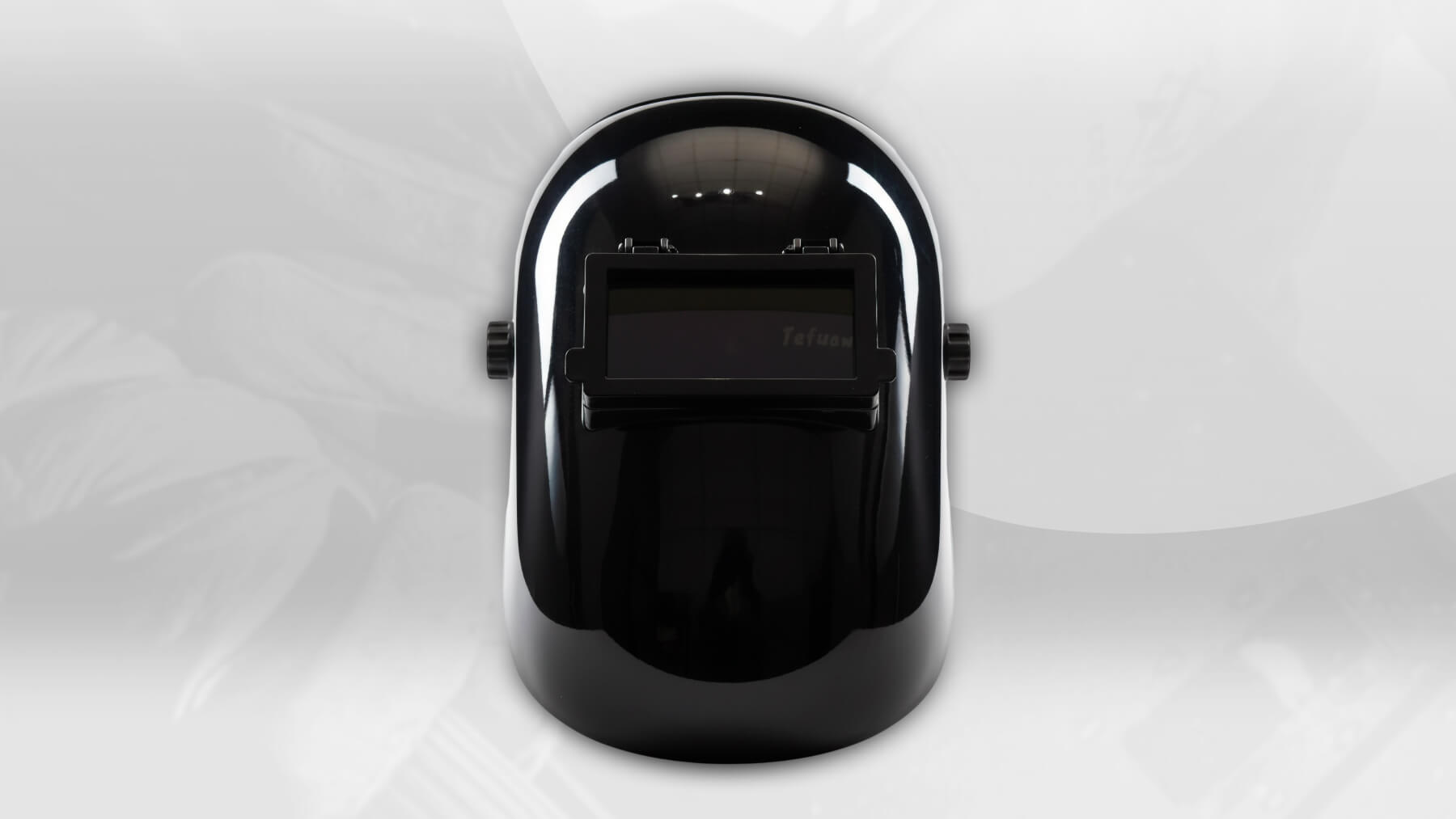 Black welding helmet on a white background