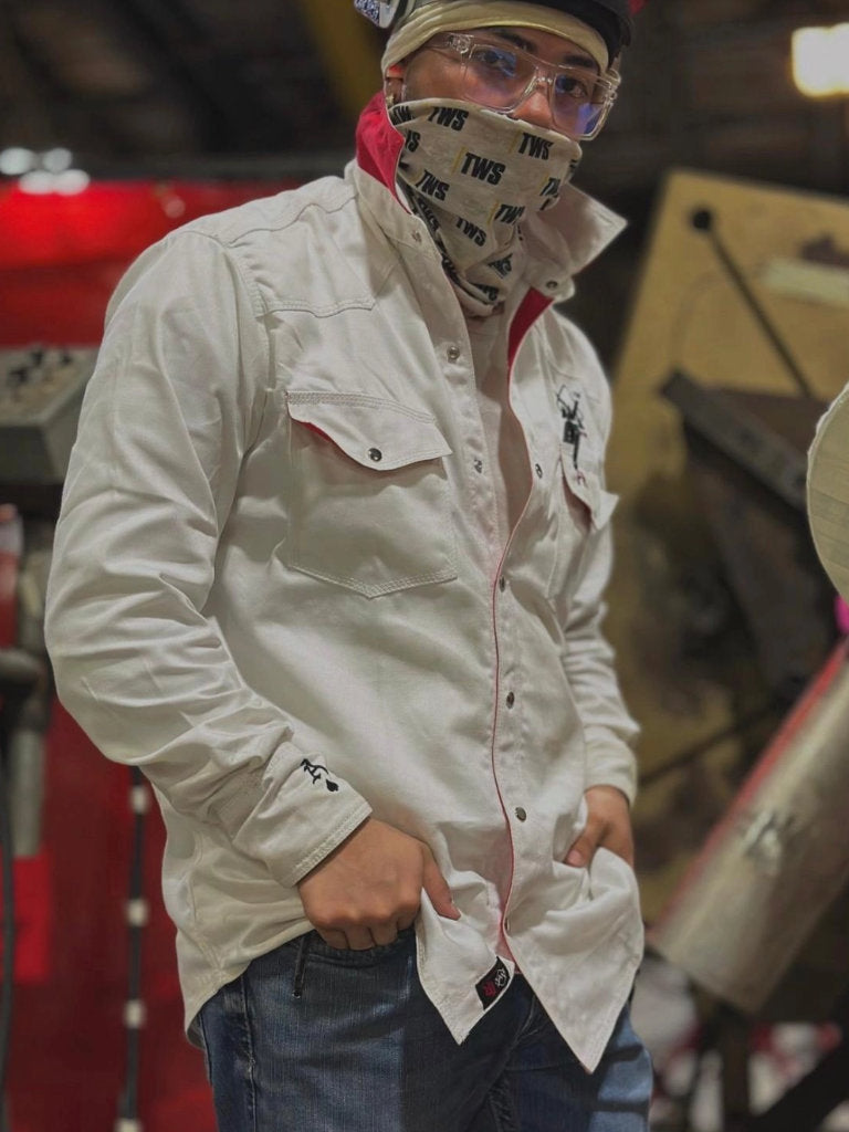 Person wearing a white shirt with a brand logo, blue jeans, and a bandana with text.