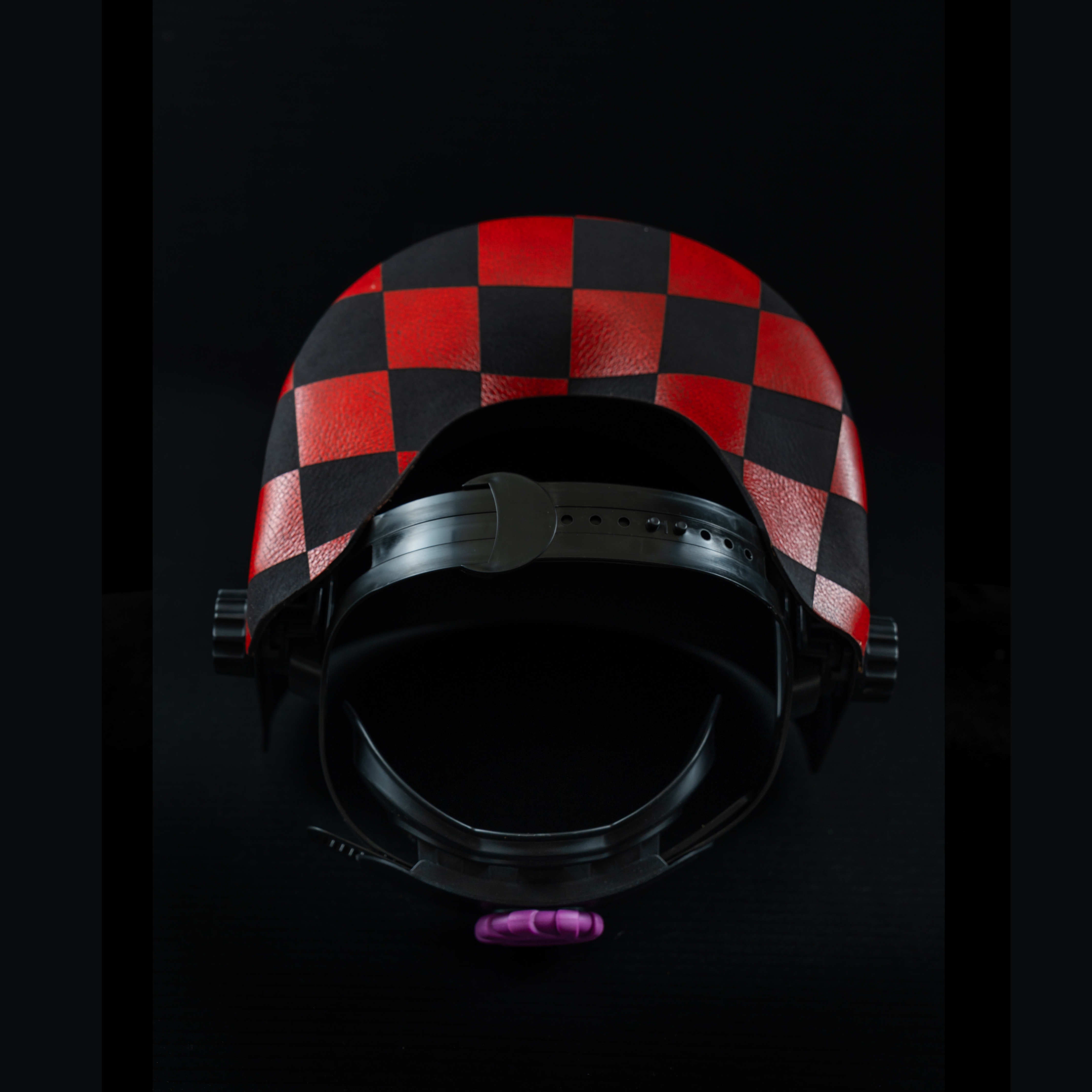 Interior view of EliteWave Welding Hood showing red and black checkered leather detail and padding.