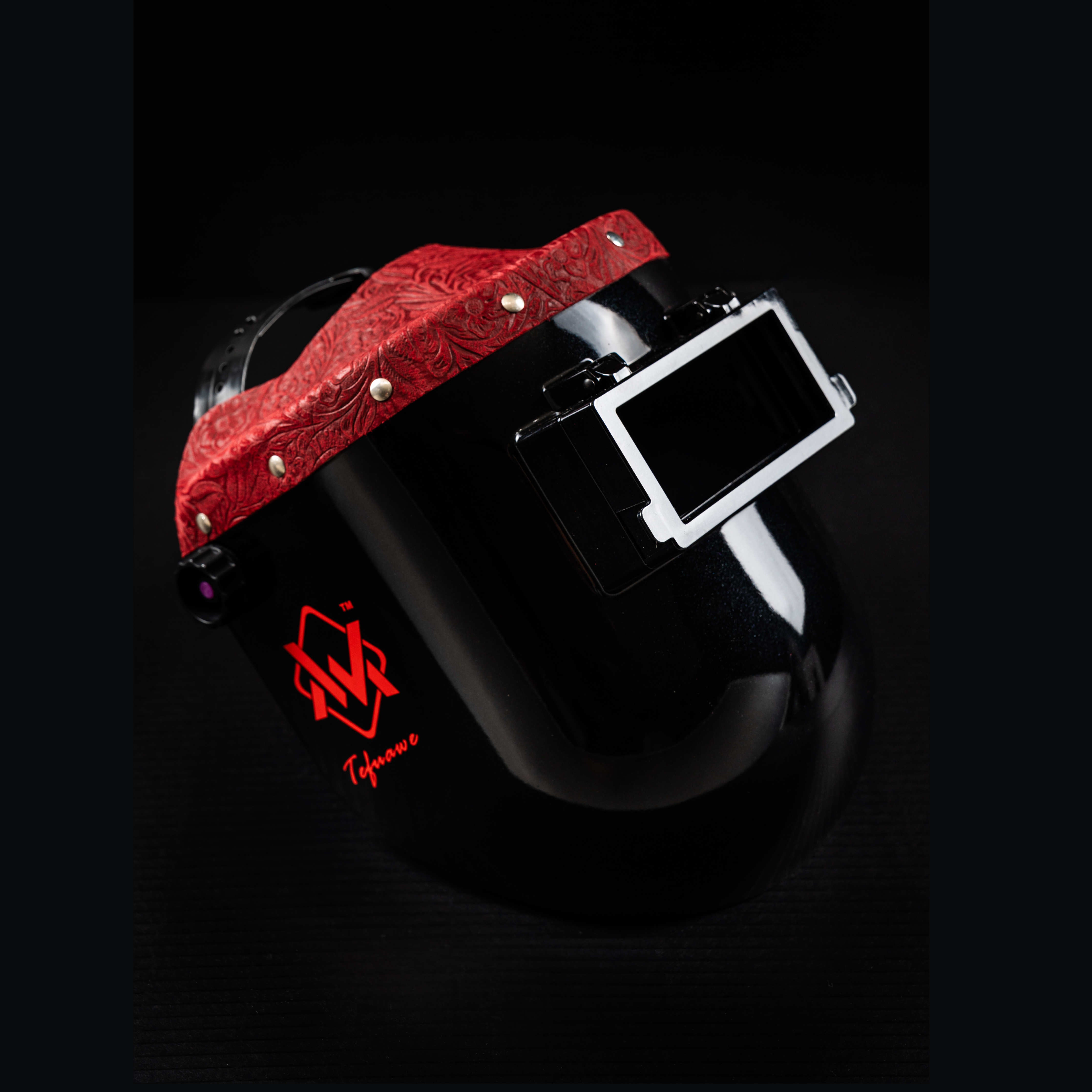 EliteWave Flip Lens Welding Hood with red floral leather trim, side view glossy black shell and flip lens.