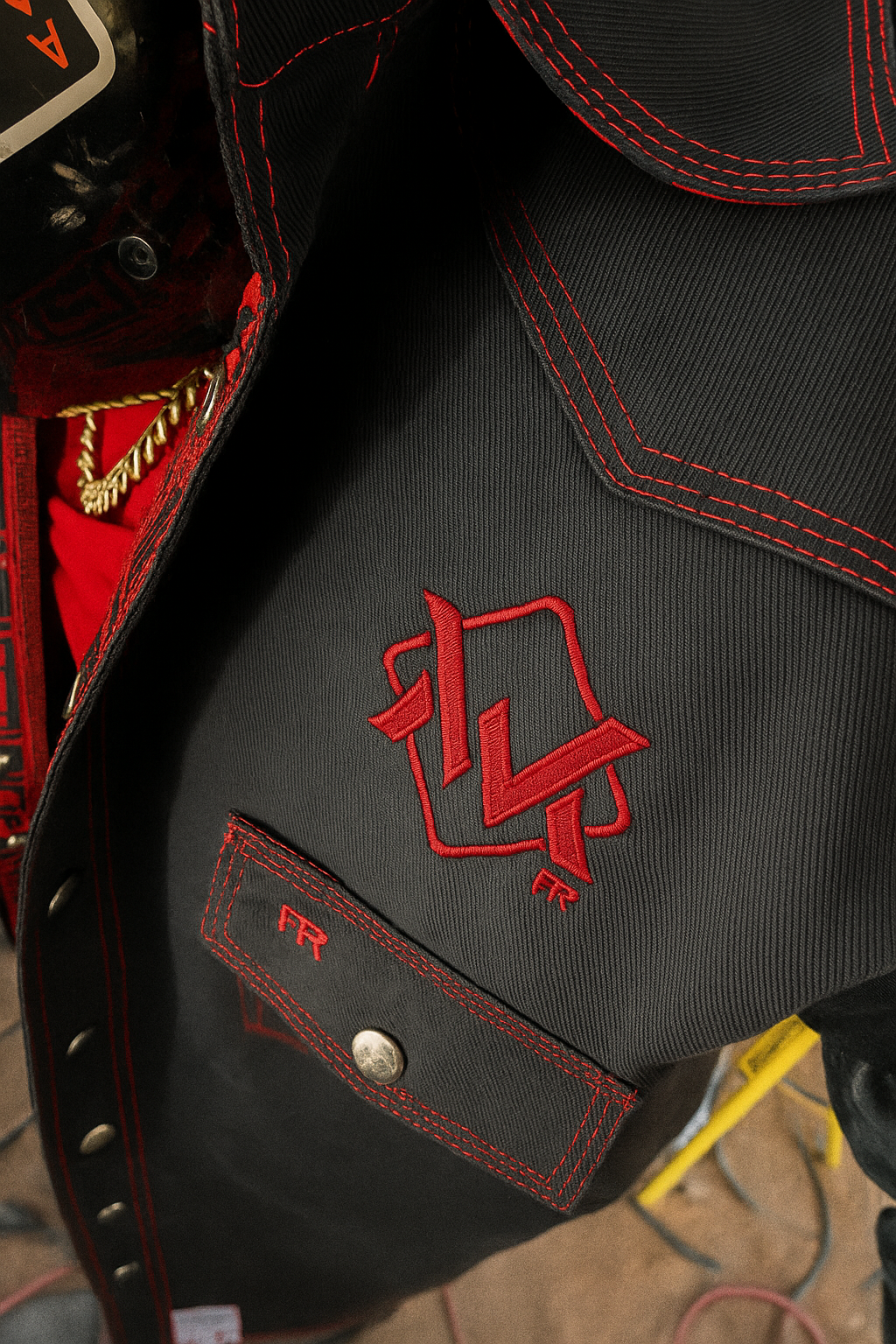 Black welding shirt with red accents displaying The Welding Magician logo