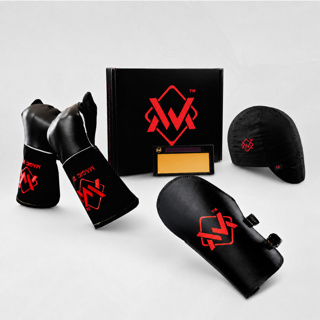 Black welding gloves, welding cap, leather arm guard, and welding lens with box on a clean gray background.