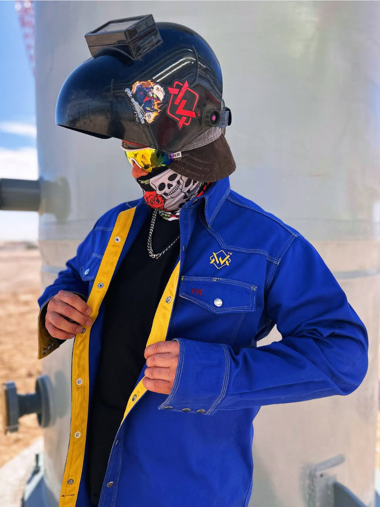 Person wearing a blue jacket and colorful helmet with various designs.