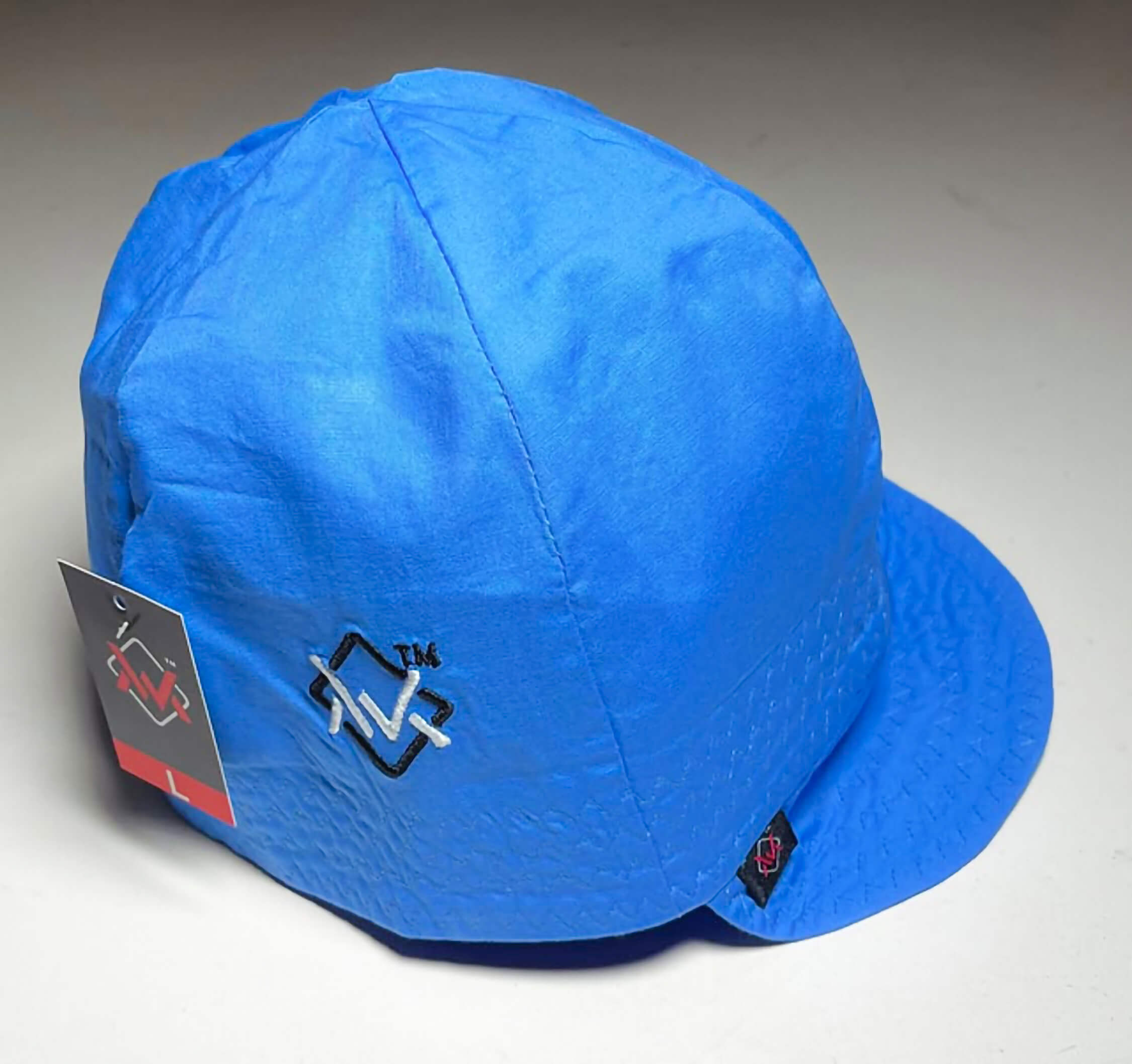 Blue cap with a brand logo on a gray background