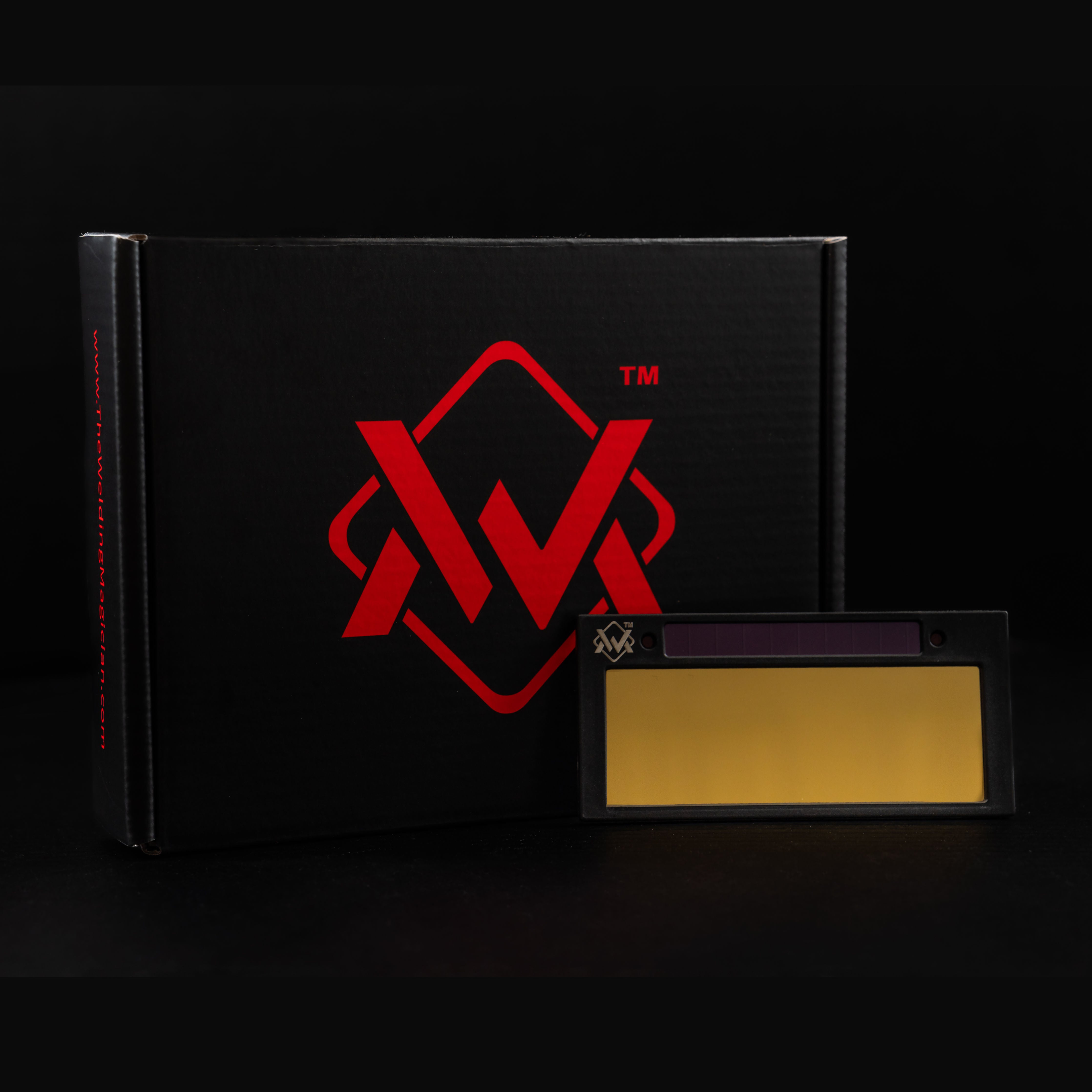WM GOLD Auto-Darkening Welding Lens with gold filter displayed beside branded box, premium packaging view.